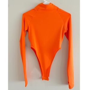 Boohoo orange turtleneck high cut one piece.